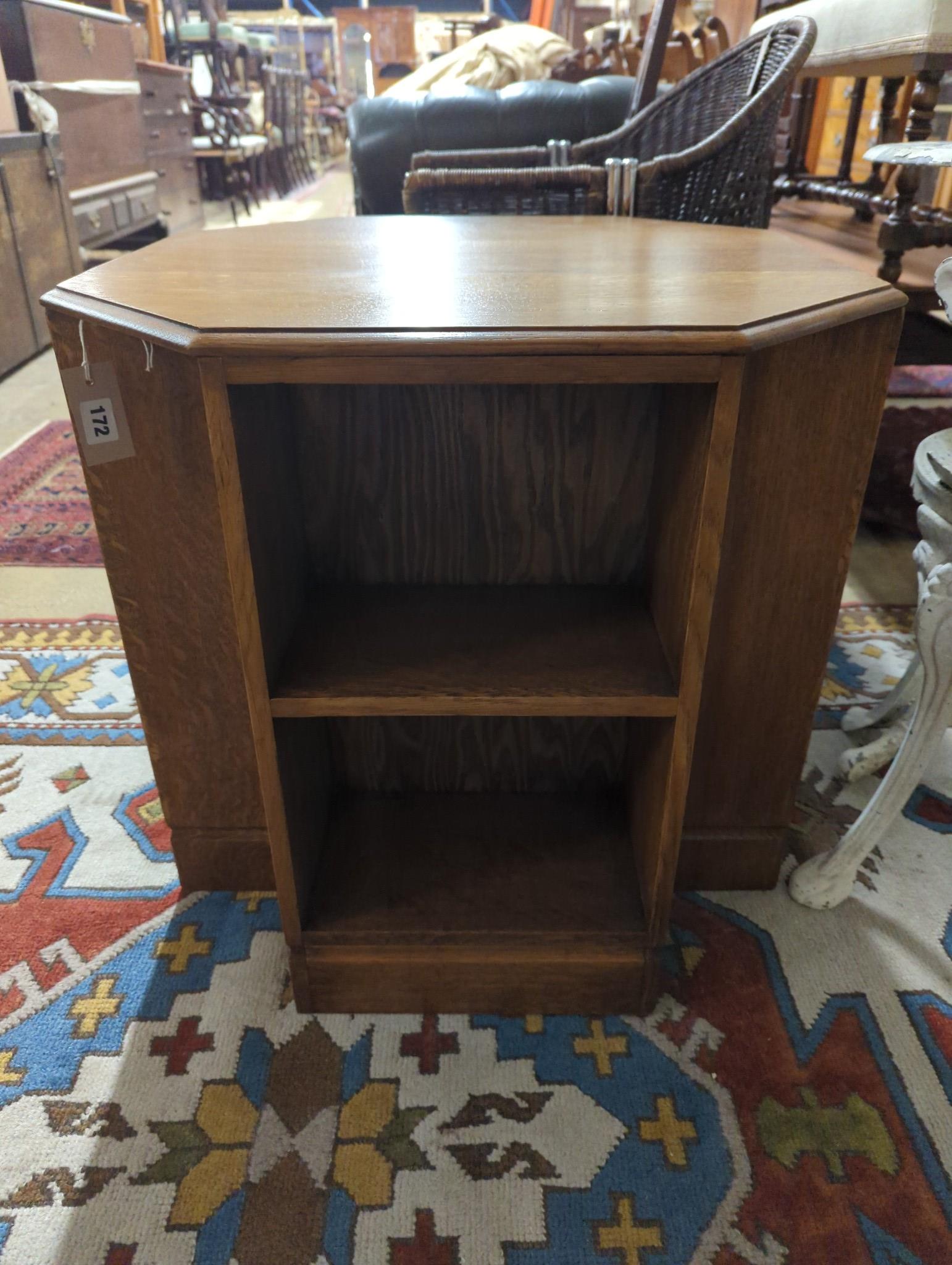 A 1930's Heals style octagonal golden oak book table, width 60cm, height 58cm